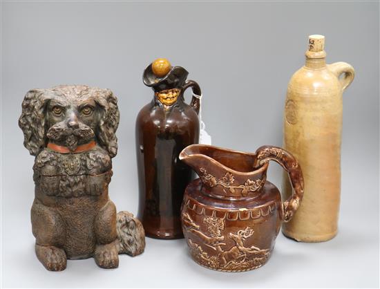 A Doulton whiskey jug, a terracotta dog tobacco jar, a flagon and a jug